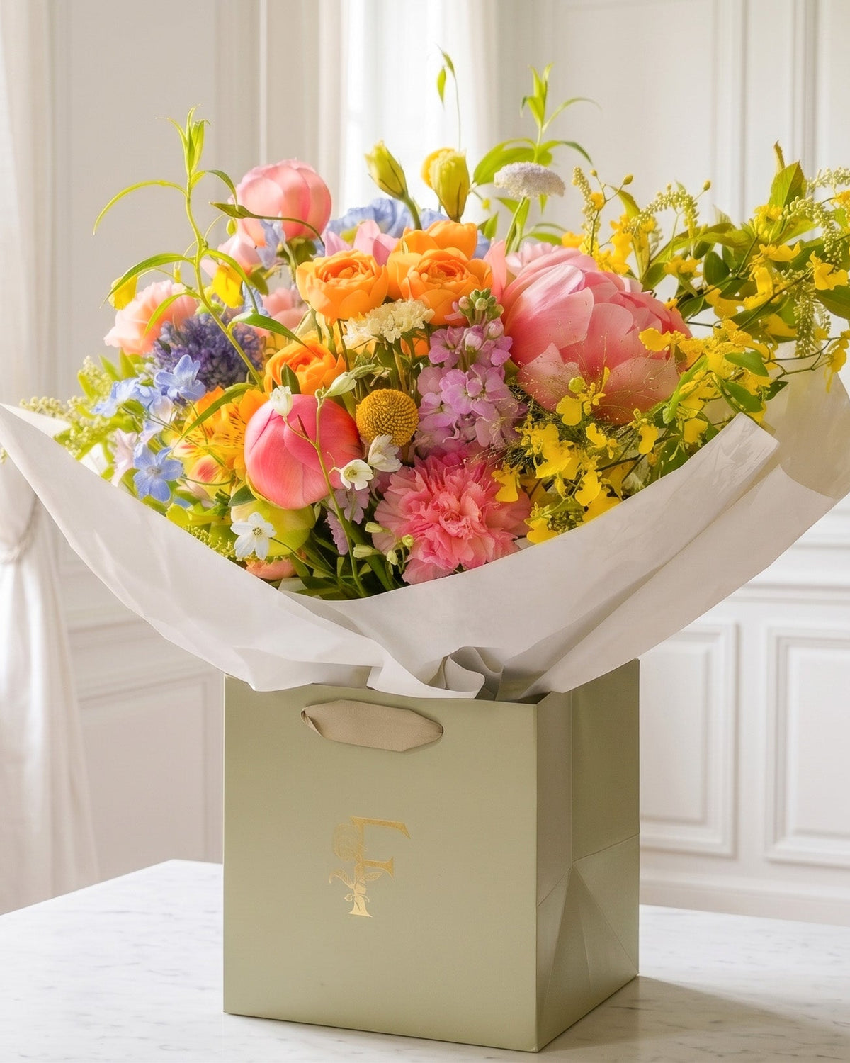 Colorful bouquet of flowers in a decorative box on a table with a window in the background